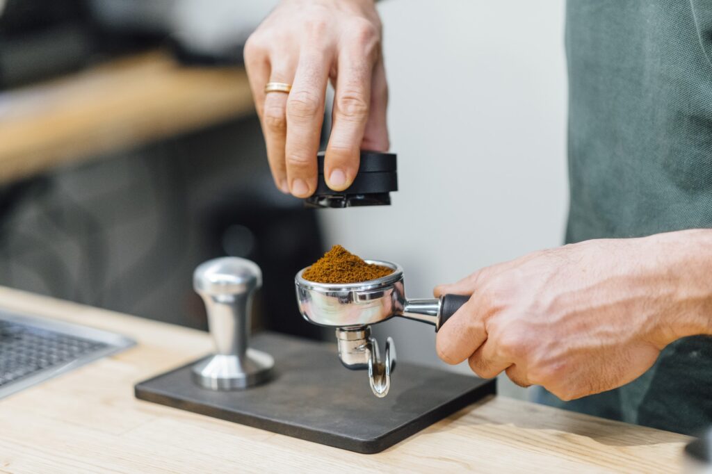 Barista pressing coffee to portafilter